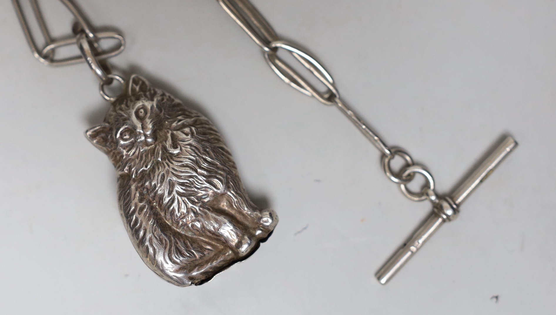 A modern silver rattle, modelled as a cat, 50mm, suspended from a 1920's silver albert.